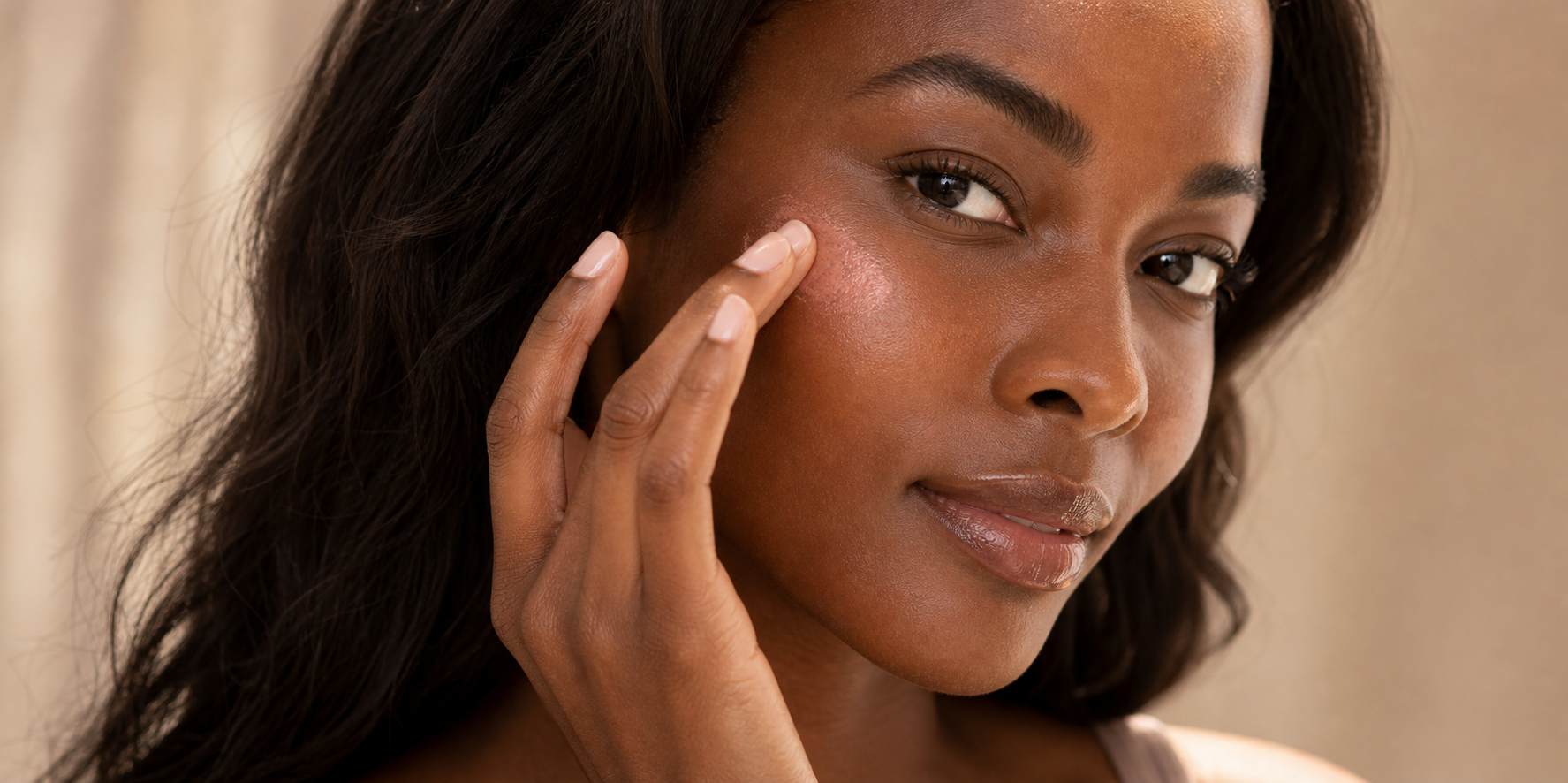 Young woman applying soft neutral eye makeup